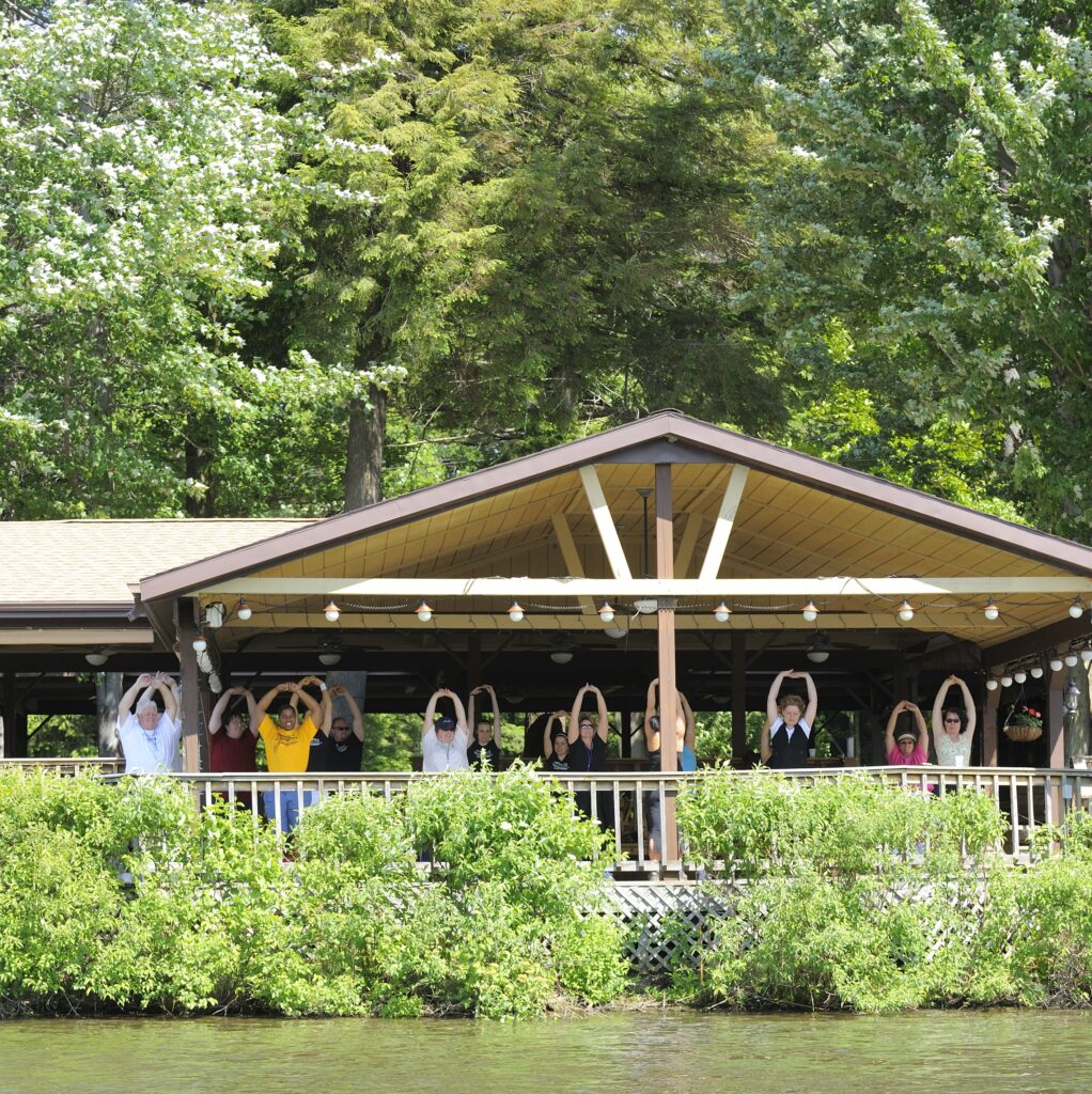 team doing stretches under a gazebo at Beaver Hollow