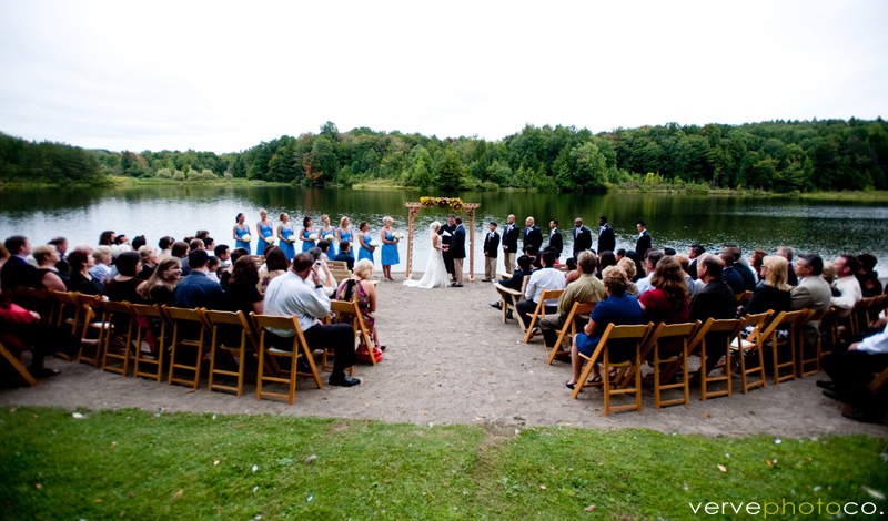 A wedding taking place at a lake.						
