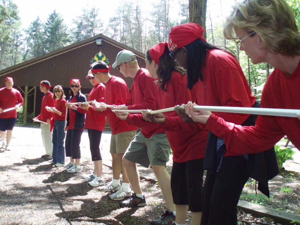 A group of employees taking part in a team building activity.						
